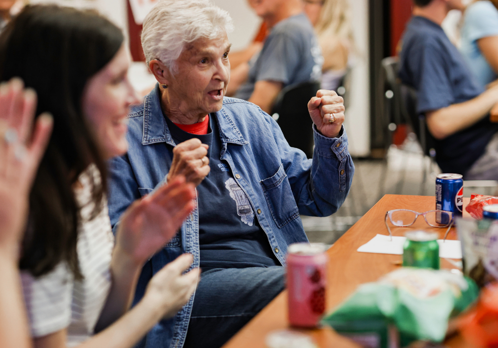 A cheerful family celebrates in a PDL meeting room. 